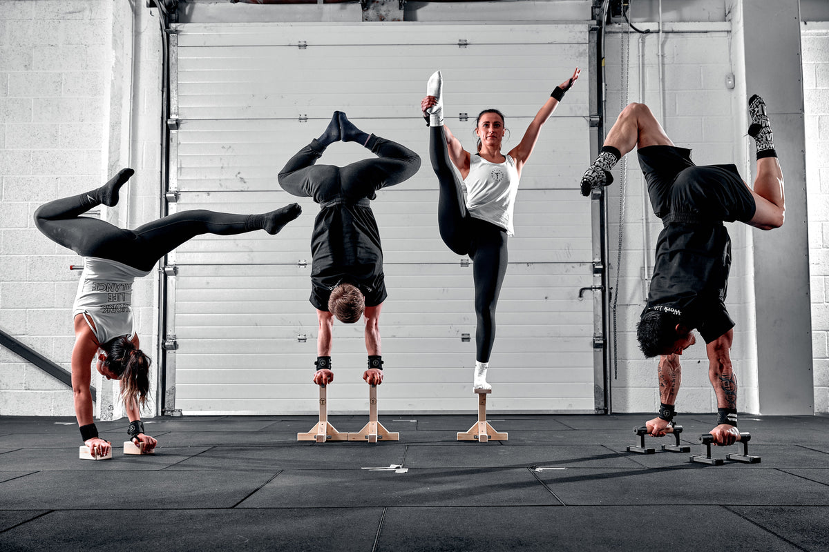 Four gymnasts performing balance poses