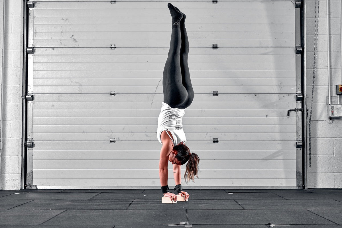Gymnast performing handstand on blocks