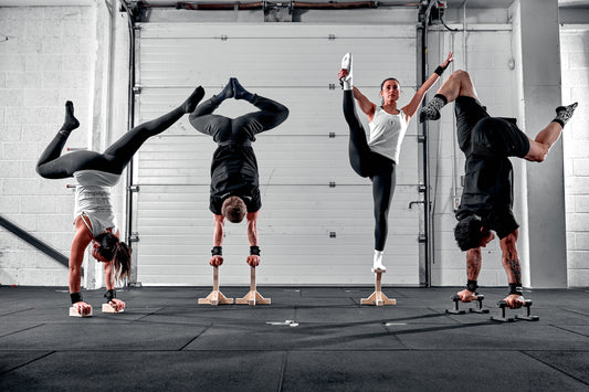 Four gymnasts performing balance poses