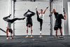 Four gymnasts performing balance poses
