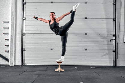 cheerleader with stunt stand smiling